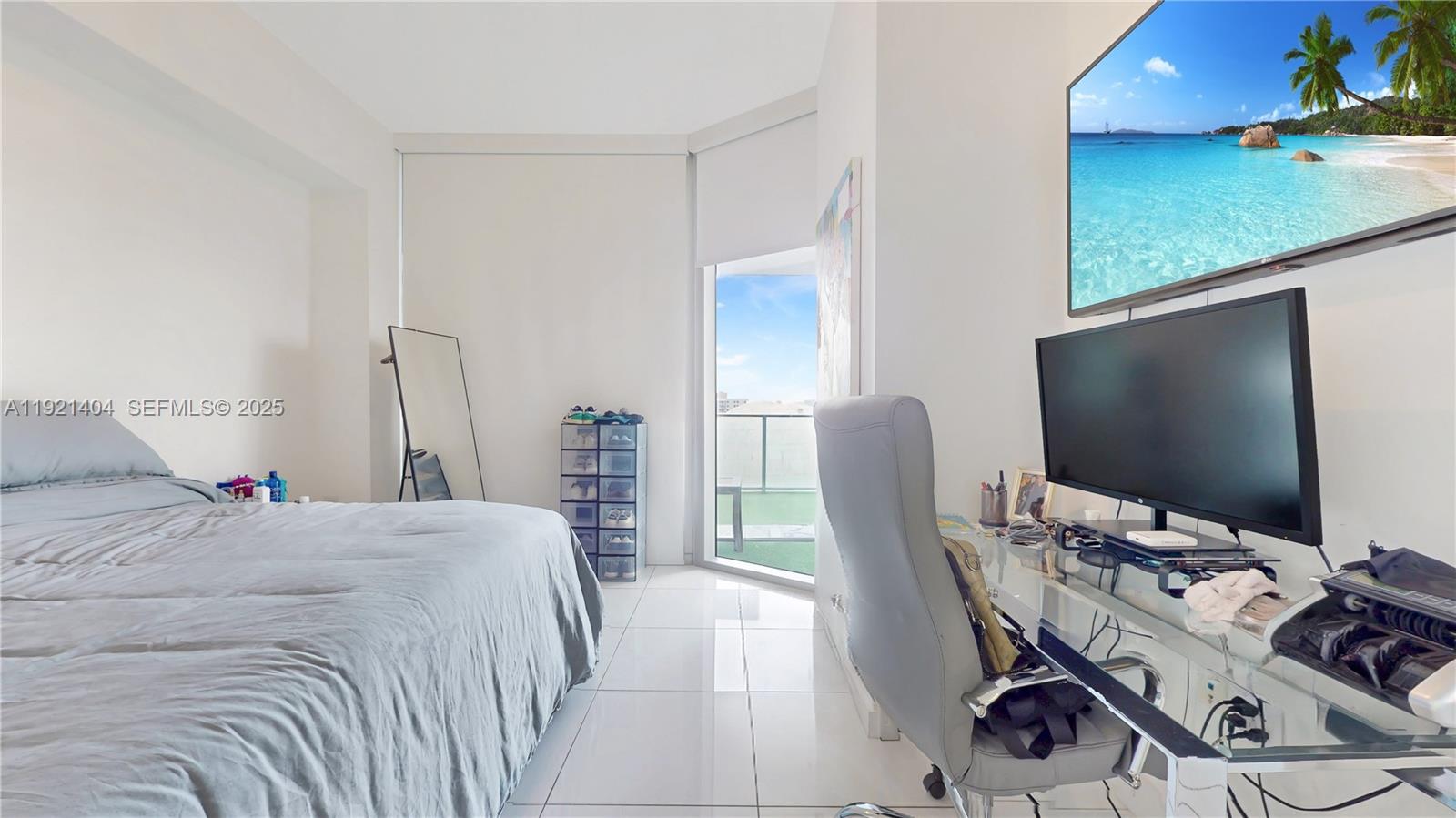 851 Northeast 1st Avenue, Unit 1508 Miami, FL 33132 - Photo 14 of 43 a bedroom with a bed and a flat screen tv