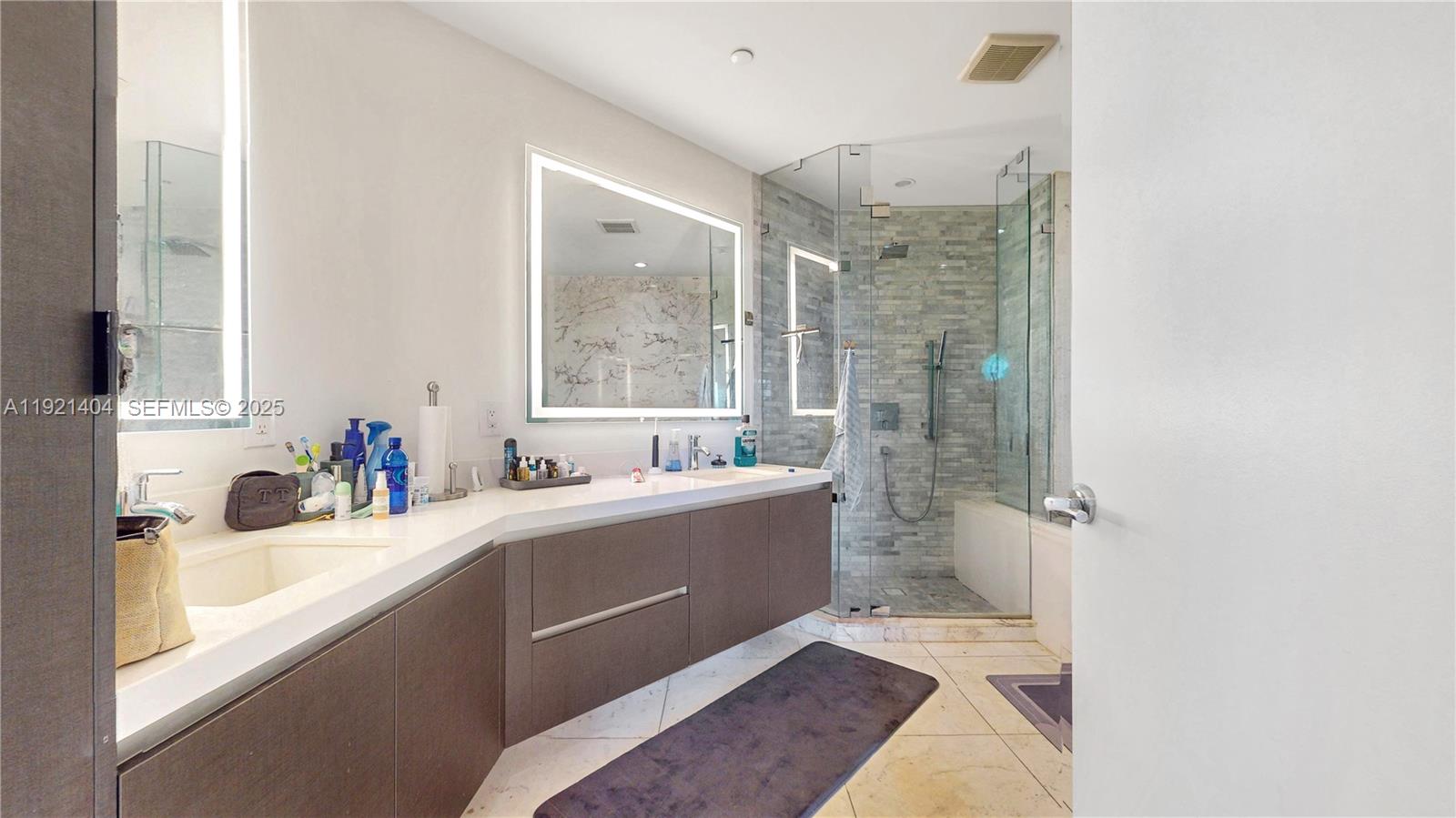 851 Northeast 1st Avenue, Unit 1508 Miami, FL 33132 - Photo 15 of 43 a bathroom with a tub sink toilet and a mirror