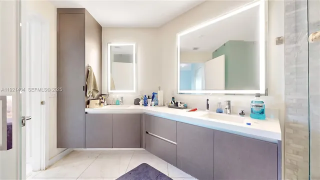 a bathroom with a double vanity sink mirror and