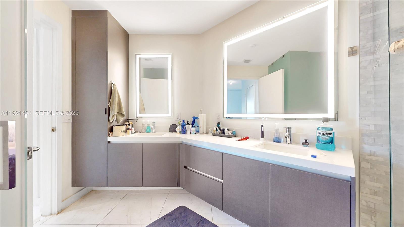 851 Northeast 1st Avenue, Unit 1508 Miami, FL 33132 - Photo 16 of 43 a bathroom with a double vanity sink mirror and