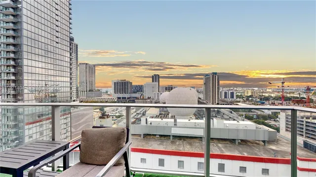 a view of a balcony with furniture and city view