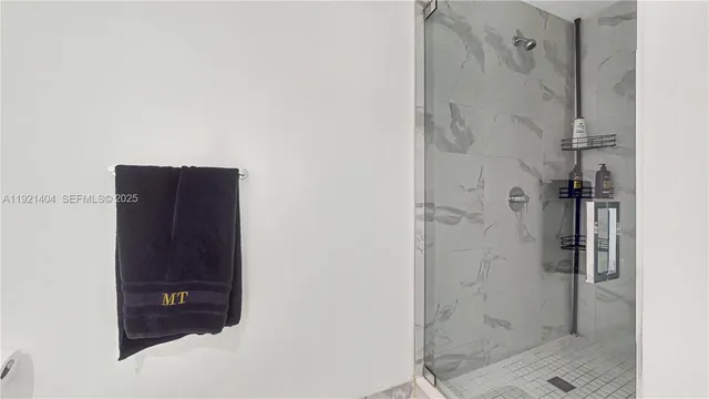 a bathroom with a shower and a mirror