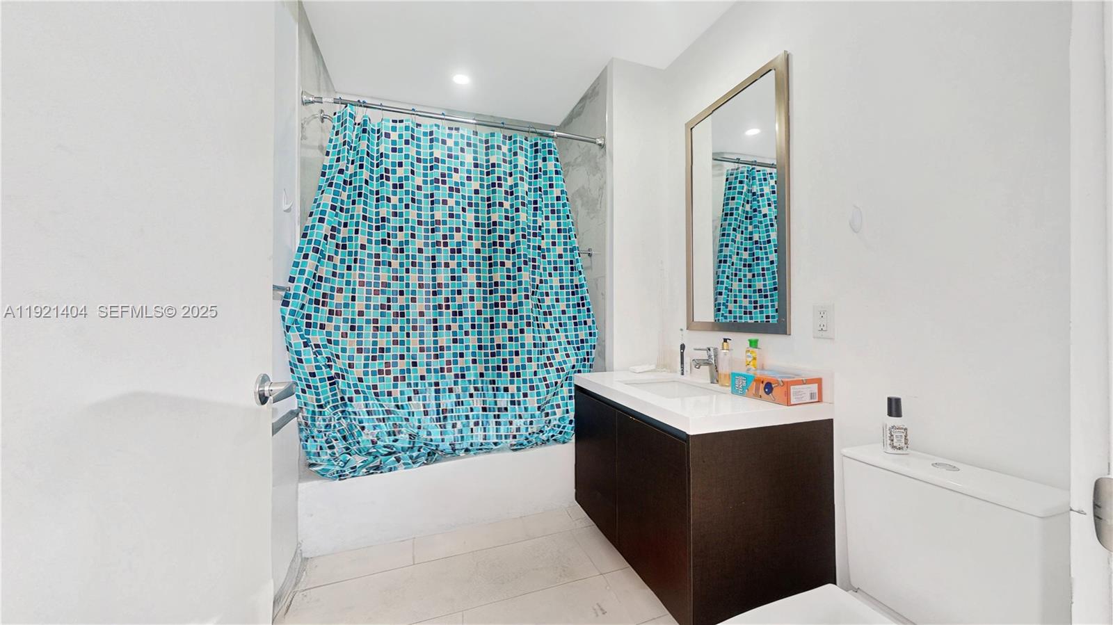 851 Northeast 1st Avenue, Unit 1508 Miami, FL 33132 - Photo 25 of 43 a bathroom with a sink a toilet and shower