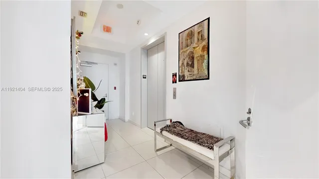a hallway with front door and rug