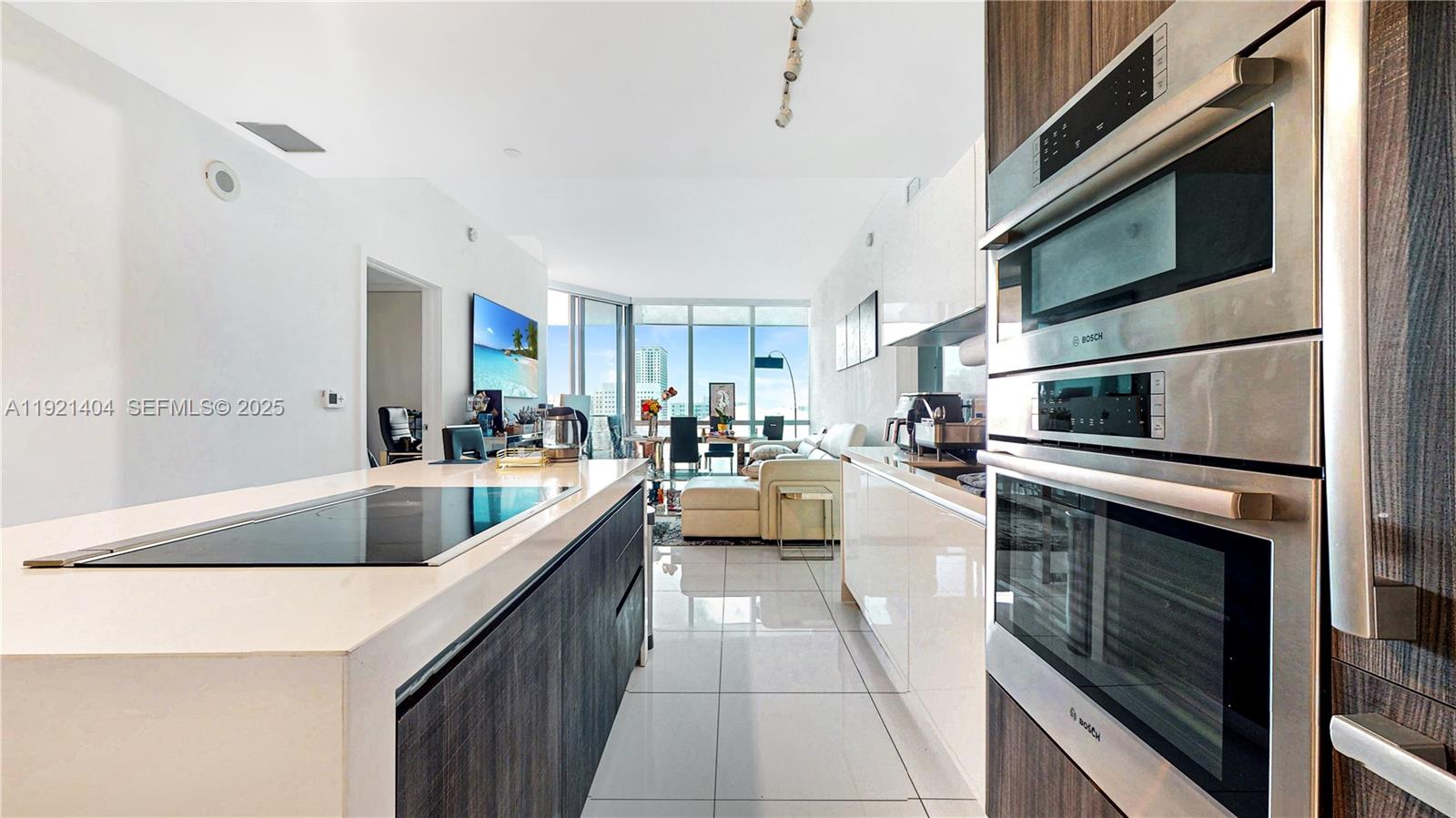 851 Northeast 1st Avenue, Unit 1508 Miami, FL 33132 - Photo 5 of 43 a kitchen with stainless steel appliances granite countertop a stove and a sink