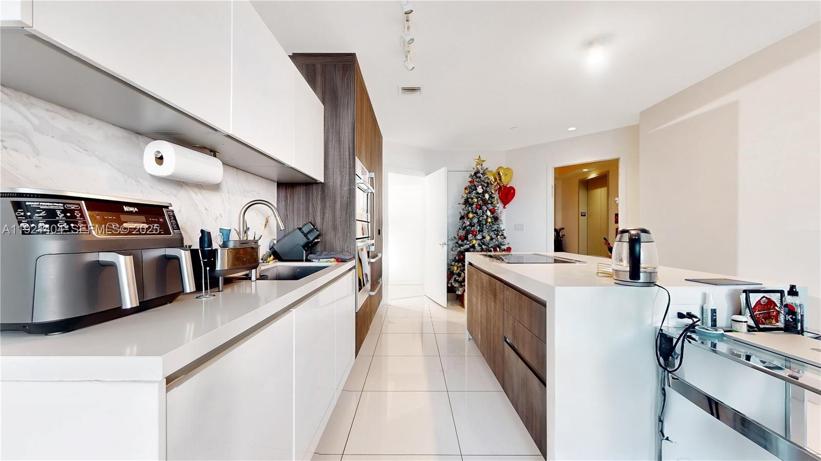 851 Northeast 1st Avenue, Unit 1508 Miami, FL 33132 - Photo 7 of 43 a kitchen with stainless steel appliances granite countertop a sink stove and refrigerator