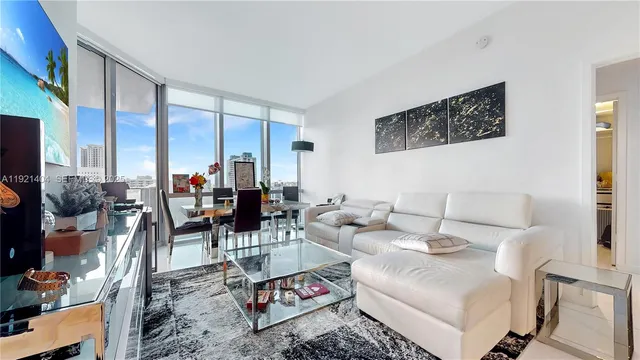 a living room with furniture and a large window