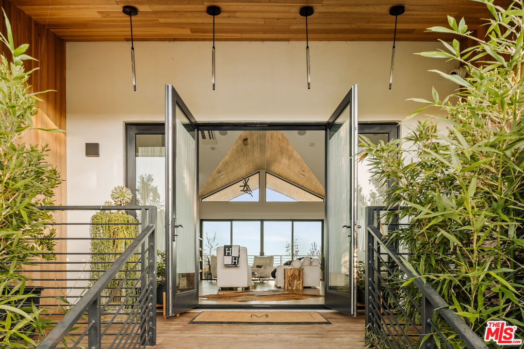 5904 Kanan Dume Road Malibu, CA 90265 - Photo 2 of 18 a view of living room with a floor to ceiling window and wooden floor