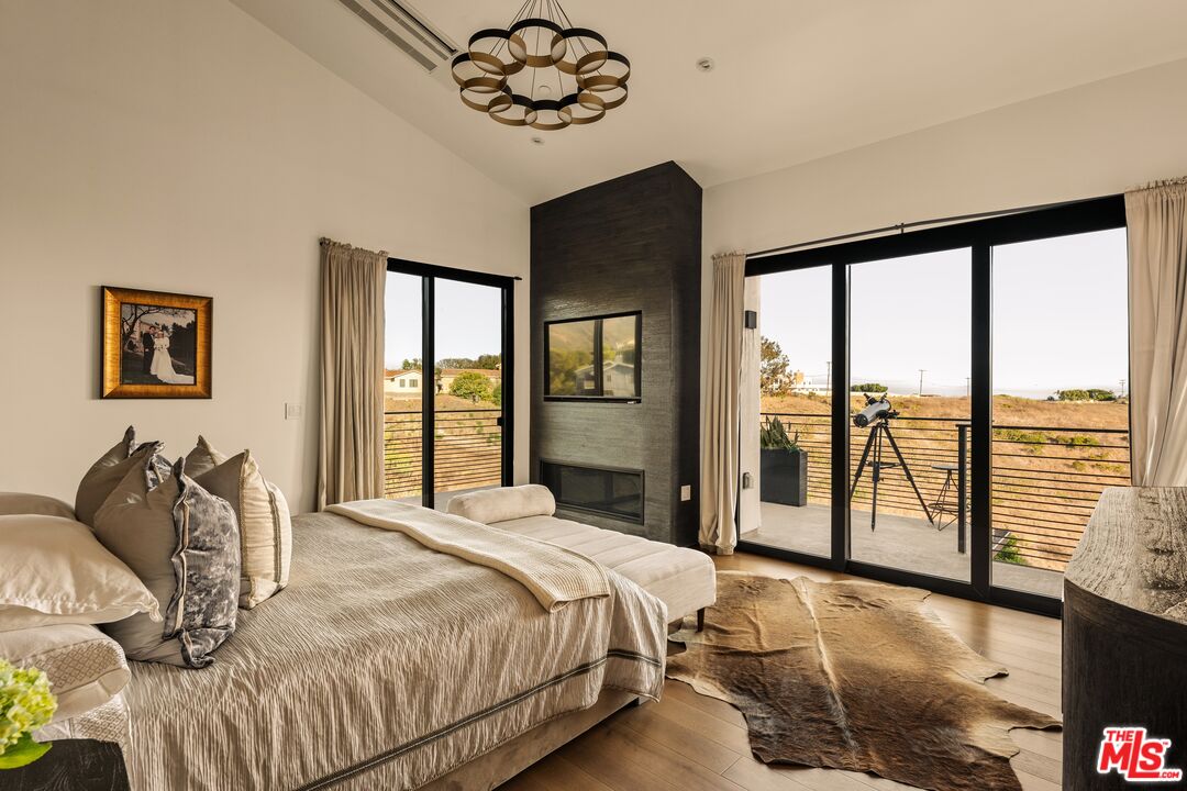 5904 Kanan Dume Road Malibu, CA 90265 - Photo 6 of 18 a bedroom with a large bed and a large window