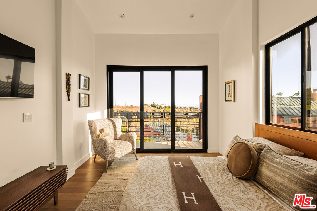 5904 Kanan Dume Road Malibu, CA 90265 - Photo 9 of 18 a bedroom with furniture and a large window
