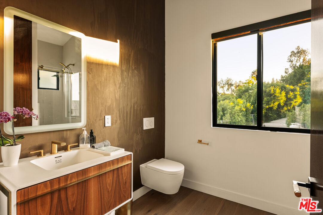 5904 Kanan Dume Road Malibu, CA 90265 - Photo 10 of 18 a bathroom with a toilet sink and mirror