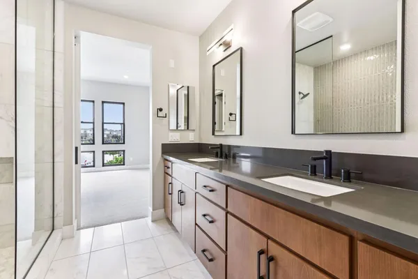 a spacious bathroom with a granite countertop sink and a mirror