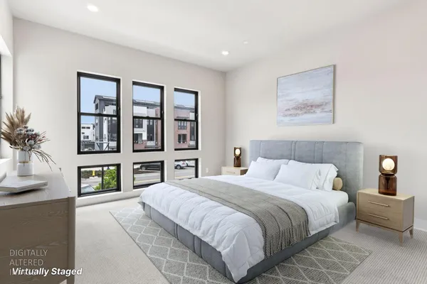 a bedroom with a large bed and a window