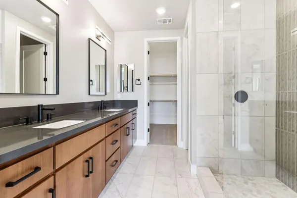 a bathroom with a double vanity sink and a mirror
