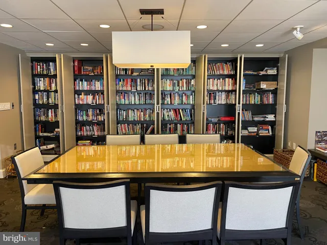 a room with pool table and windows