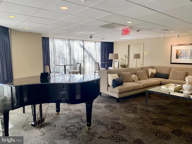 a living room with furniture a rug and a chandelier
