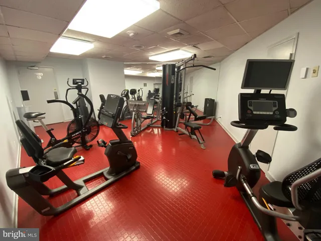 a room with gym equipment and a flat screen tv