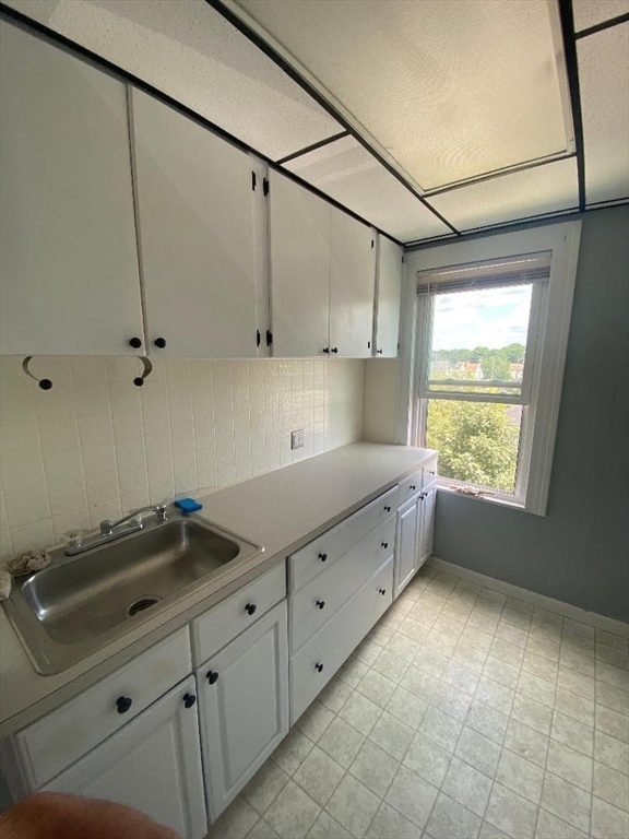 269 Stetson Street, Unit 2 Fall River, MA 02720 - Photo 3 of 12 a kitchen with granite countertop a sink window and cabinets