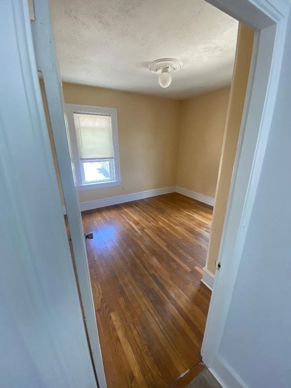 269 Stetson Street, Unit 2 Fall River, MA 02720 - Photo 7 of 12 a view of empty room with wooden floor