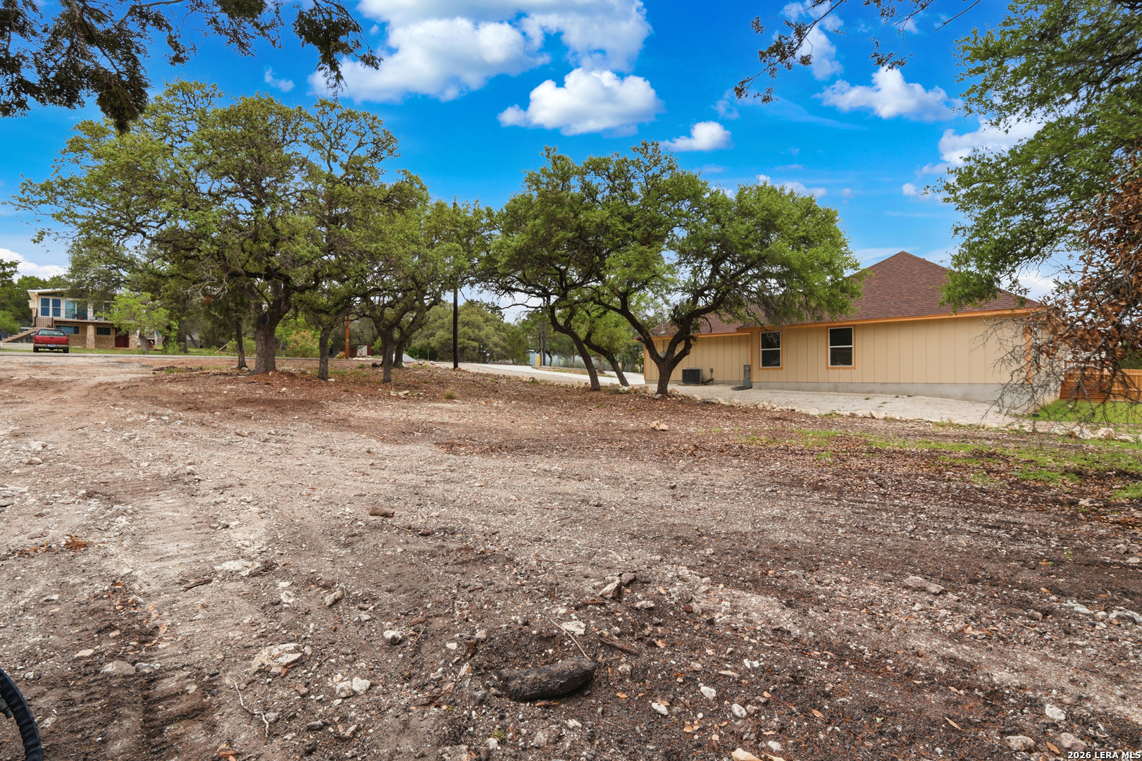1532 Rimrock Cove Spring Branch, TX 78070 - Photo 3 of 4 a view of dirt yard with a large tree