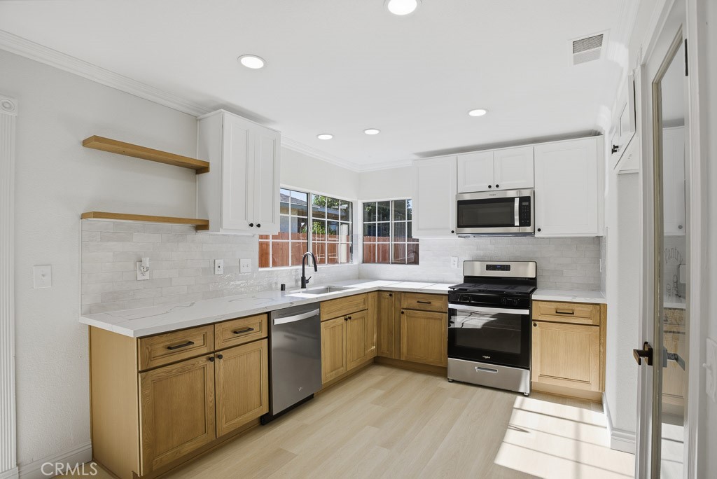 7051 Idyllwild Lane Riverside, CA 92503 - Photo 12 of 40 a kitchen with stainless steel appliances granite countertop refrigerator sink and stove