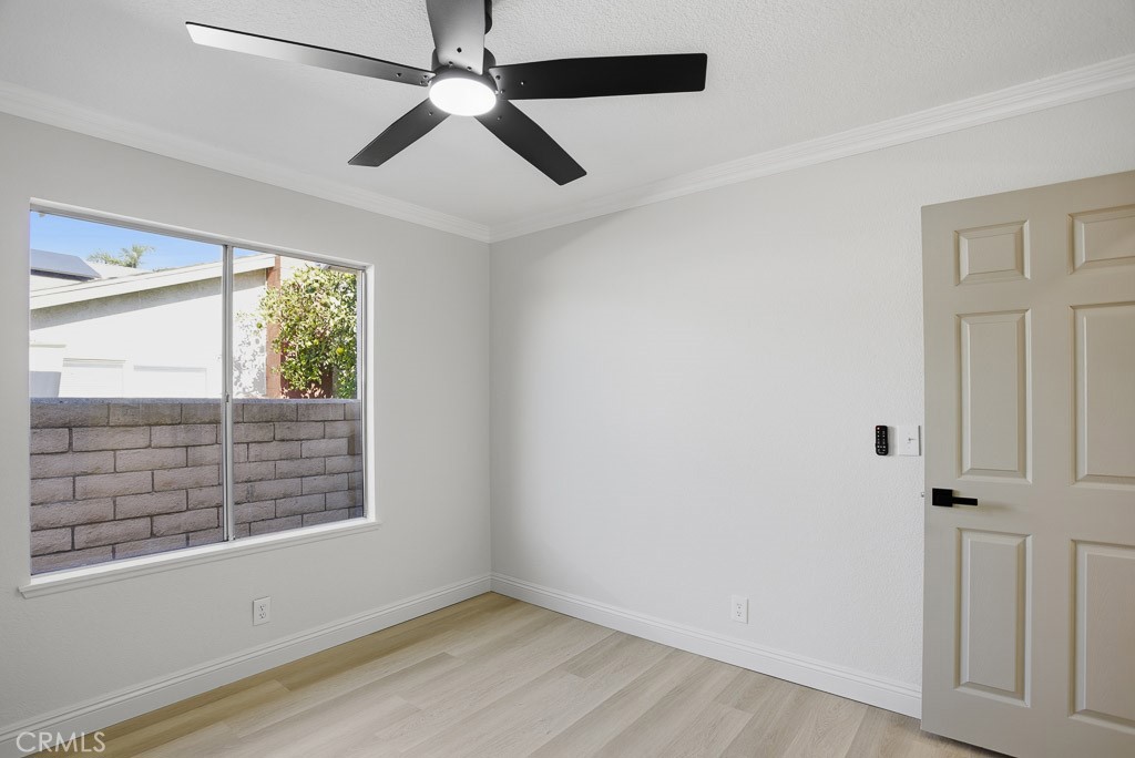 7051 Idyllwild Lane Riverside, CA 92503 - Photo 17 of 40 an empty room with windows and fan