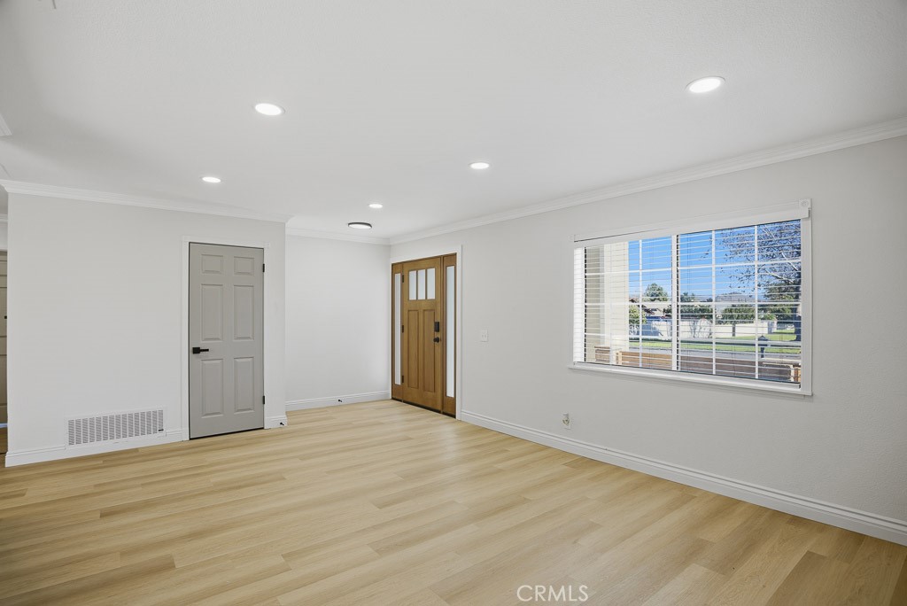 7051 Idyllwild Lane Riverside, CA 92503 - Photo 5 of 40 a view of an empty room with wooden floor and a window