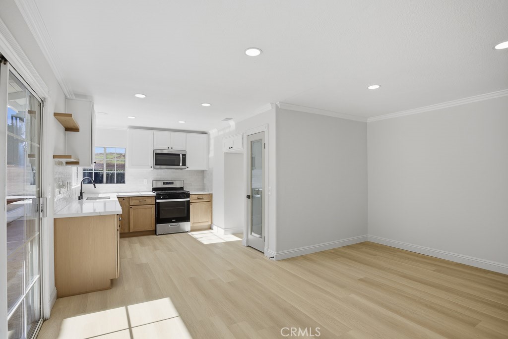 7051 Idyllwild Lane Riverside, CA 92503 - Photo 9 of 40 a kitchen with stainless steel appliances a refrigerator and a stove top oven