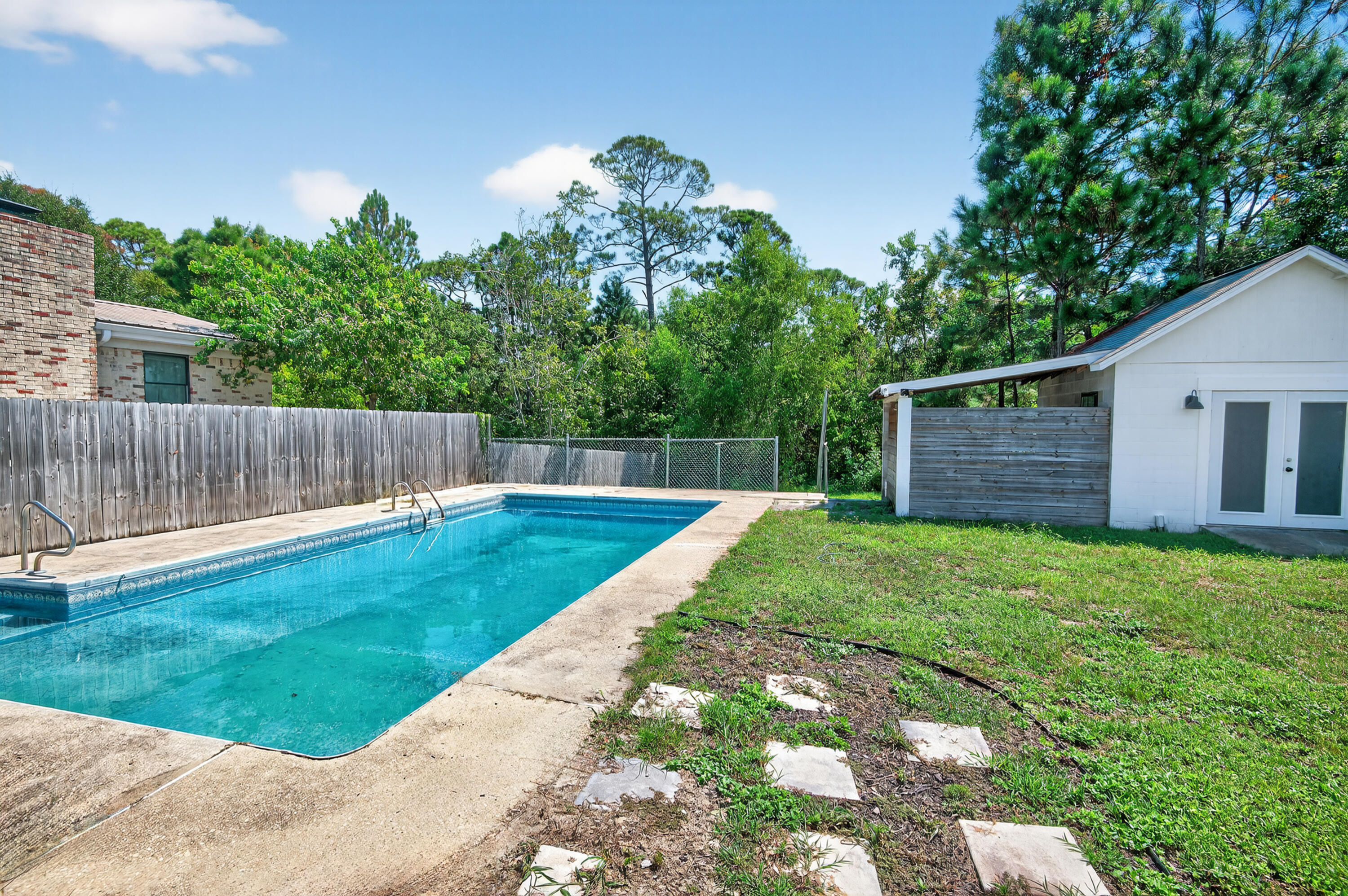 115 Ridgewood Avenue Mary Esther, FL 32569 - Photo 11 of 54 a view of a backyard with a garden and plants