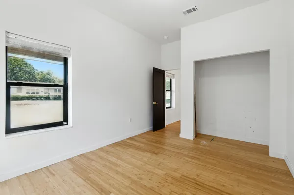 a living room with lots of furniture and kitchen view