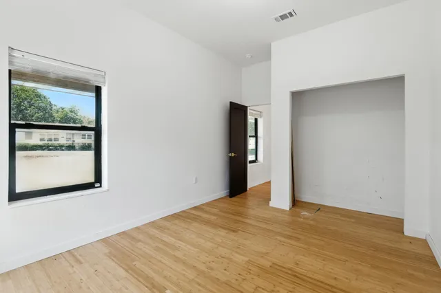 a living room with lots of furniture and kitchen view