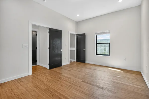 a bedroom with a bed and painting on the wall