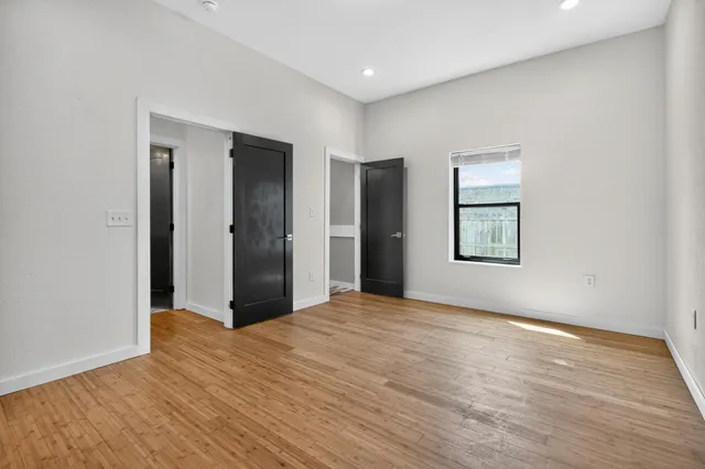 a bedroom with a bed and painting on the wall