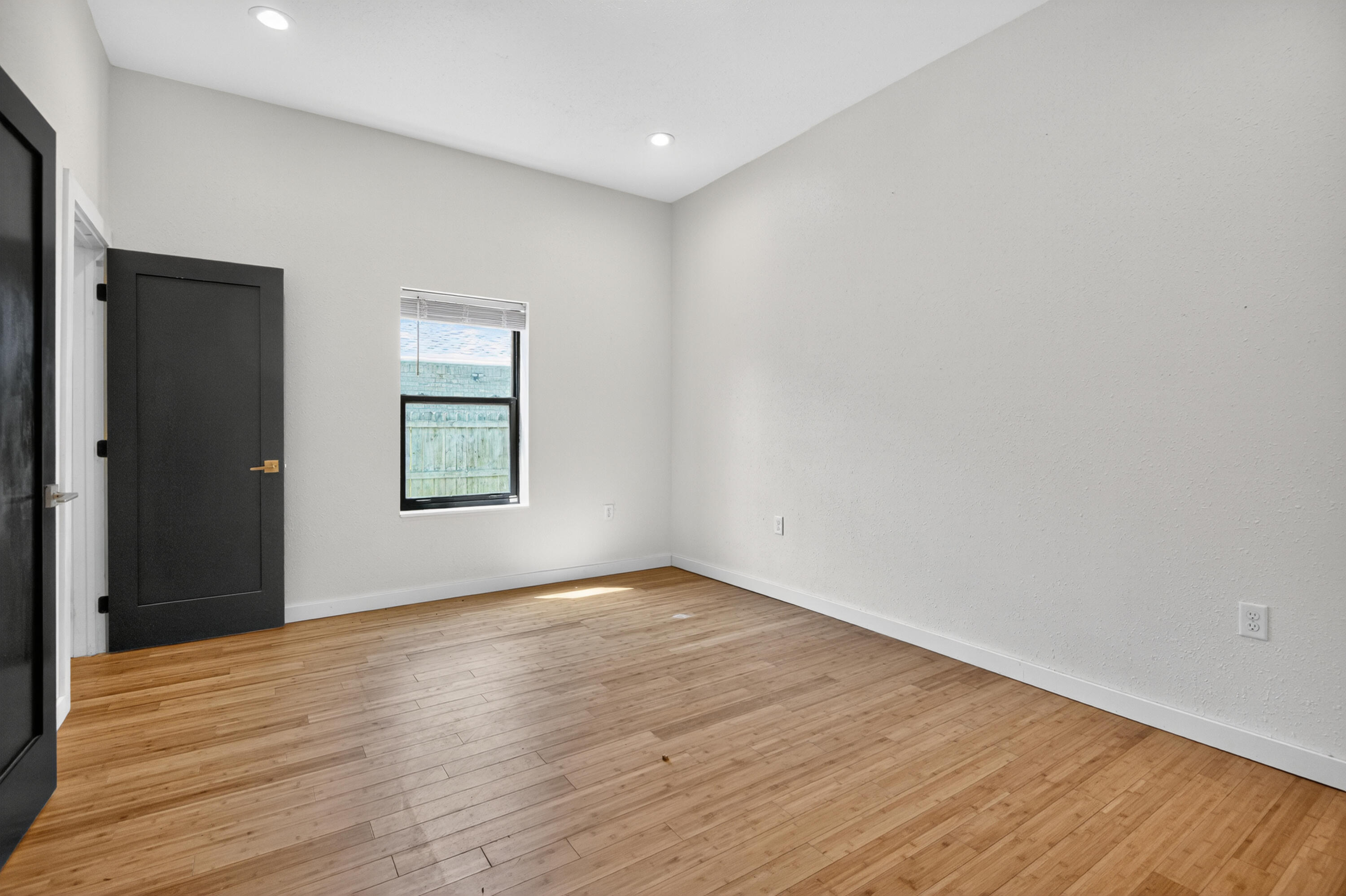 115 Ridgewood Avenue Mary Esther, FL 32569 - Photo 20 of 54 a view of an empty room with wooden floor and a window