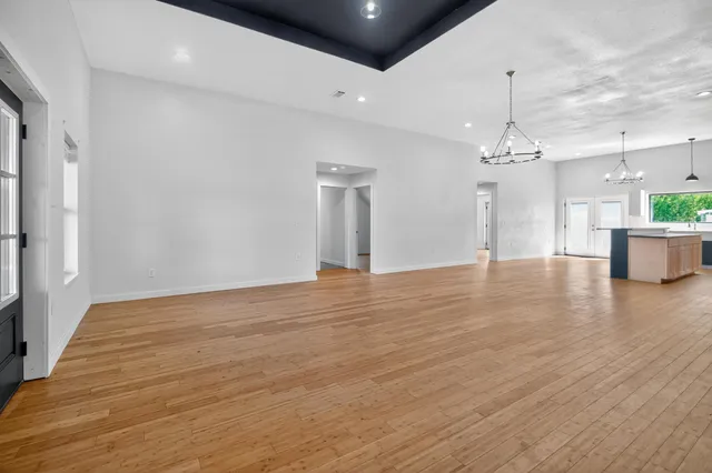 a kitchen with stainless steel appliances granite countertop a refrigerator a stove and a sink