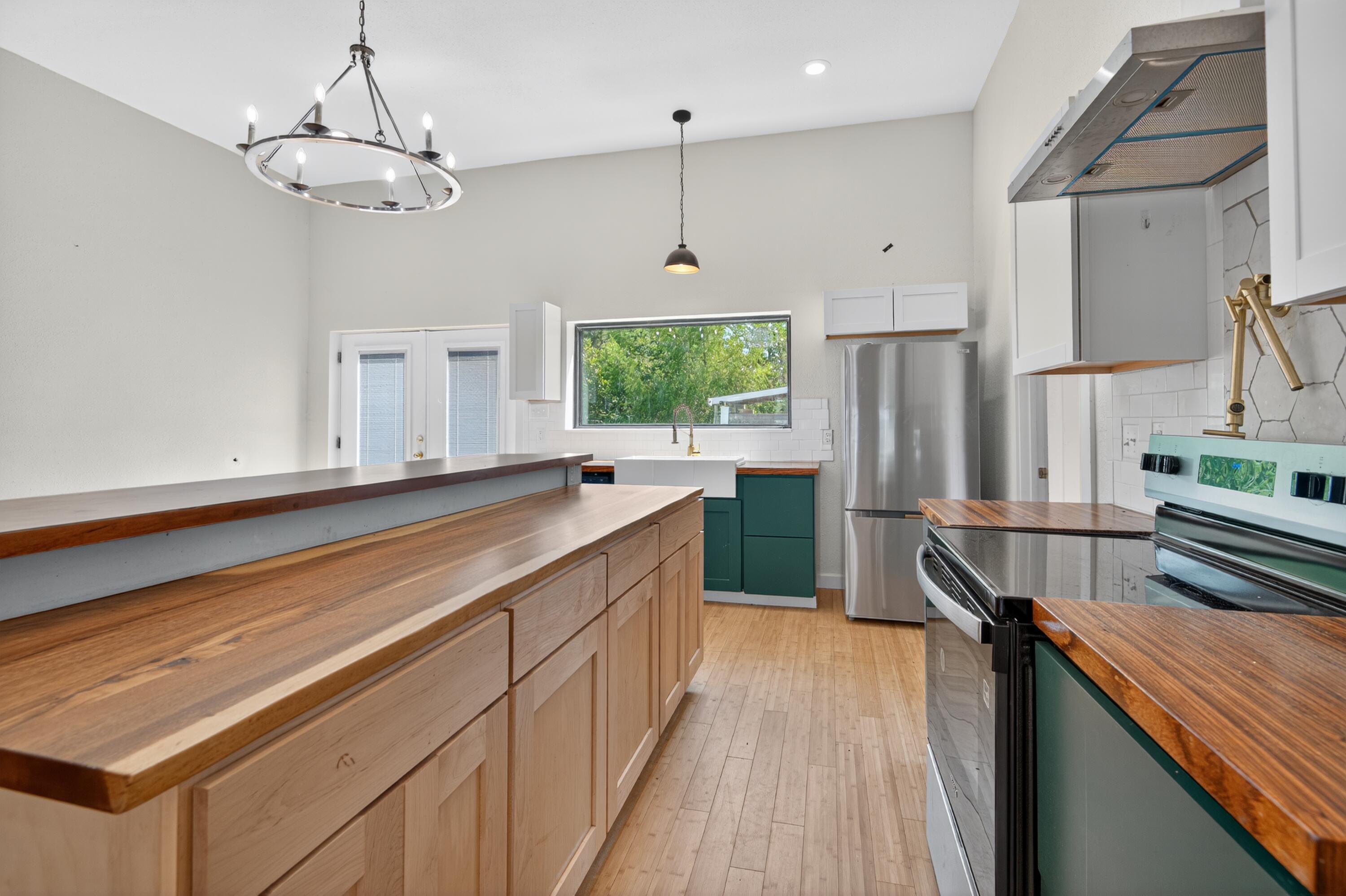 115 Ridgewood Avenue Mary Esther, FL 32569 - Photo 26 of 54 a kitchen with stainless steel appliances granite countertop a sink refrigerator and microwave