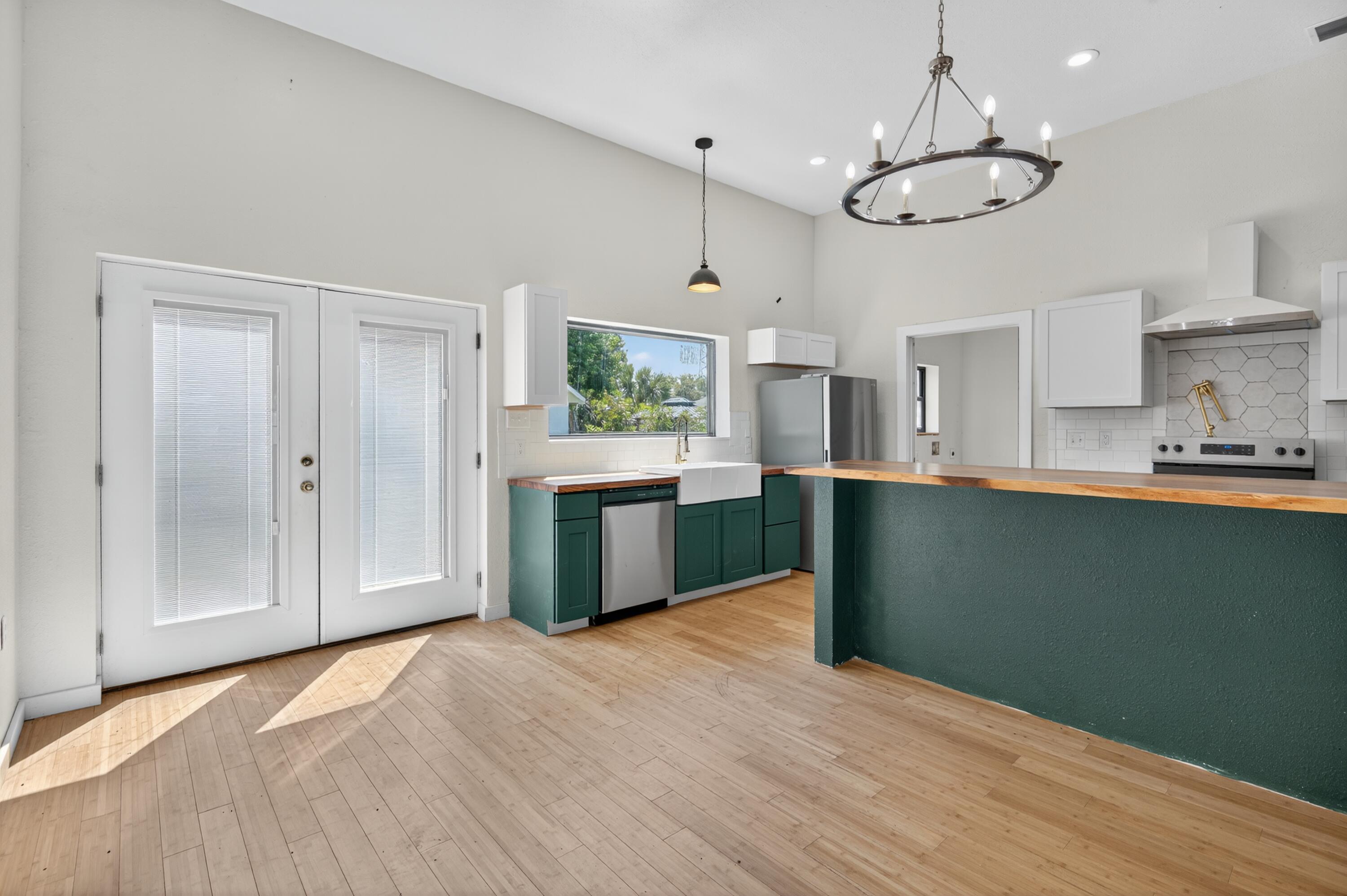 115 Ridgewood Avenue Mary Esther, FL 32569 - Photo 27 of 54 a kitchen with stainless steel appliances granite countertop a sink a stove a refrigerator cabinets and wooden floor