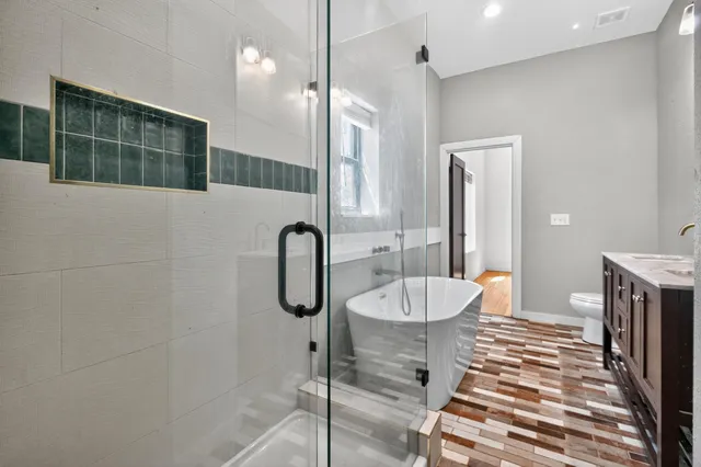 a en suite bathroom with a bathtub sink and mirror