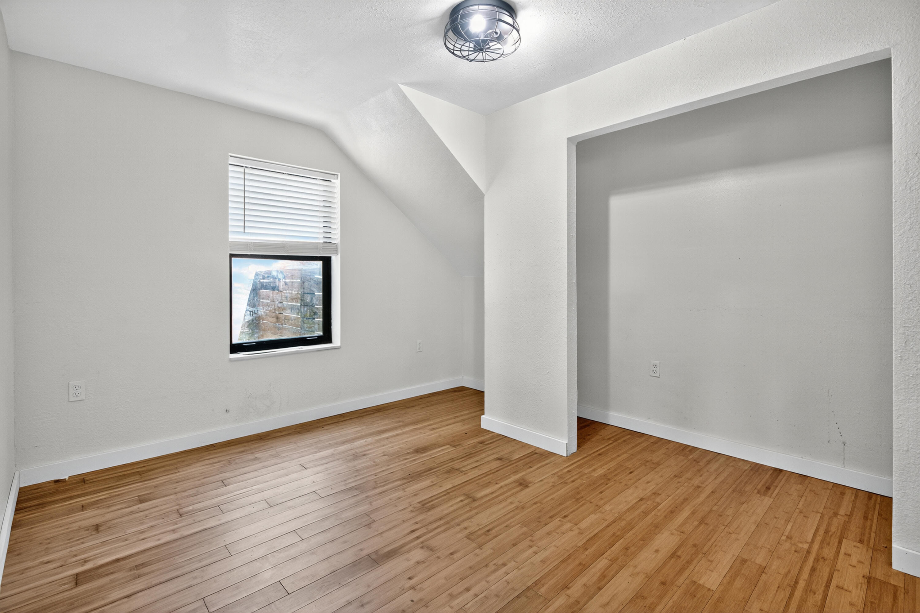 115 Ridgewood Avenue Mary Esther, FL 32569 - Photo 44 of 54 an empty room with wooden floor and windows