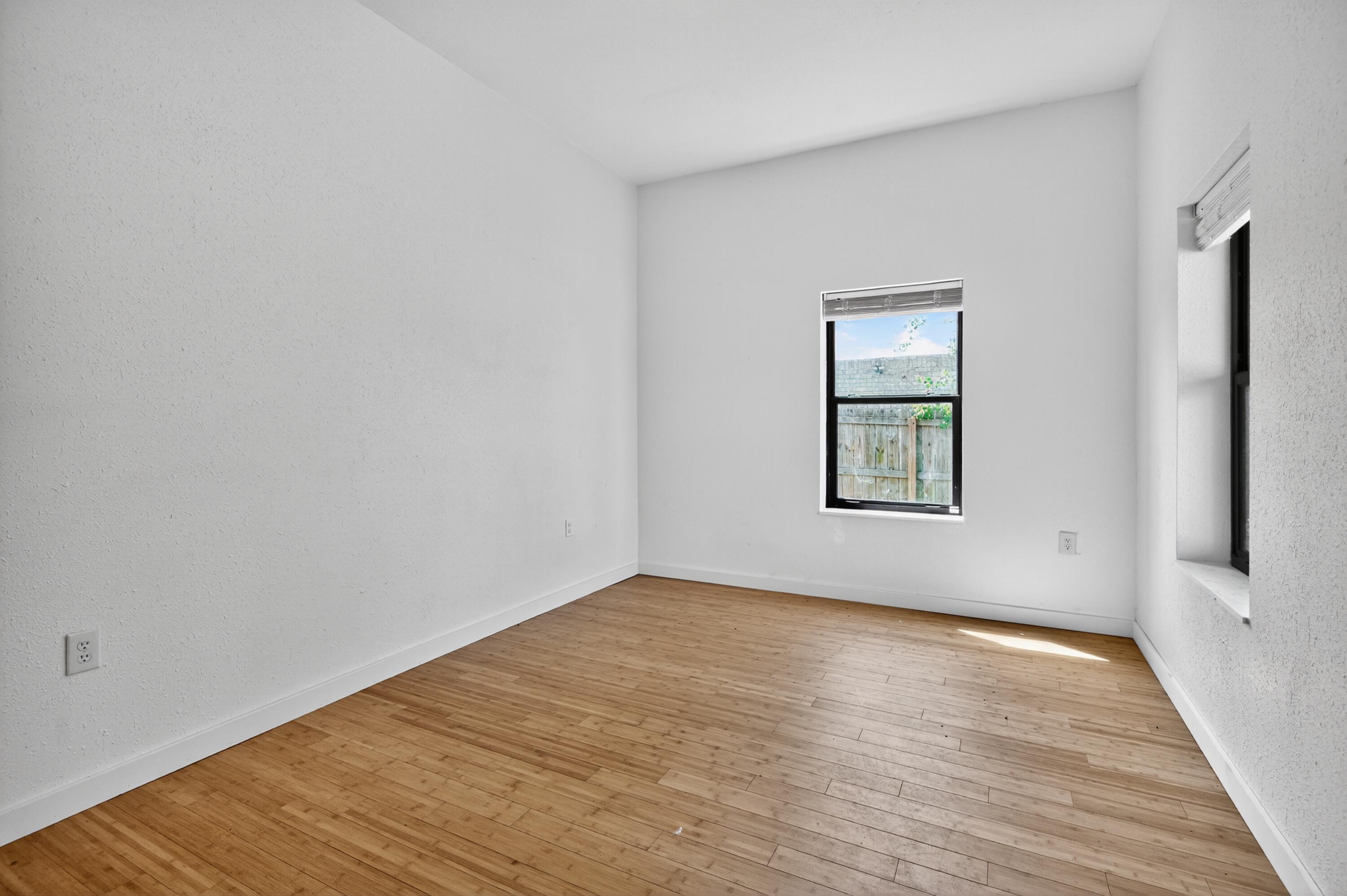 115 Ridgewood Avenue Mary Esther, FL 32569 - Photo 48 of 54 wooden floor in an empty room with a window
