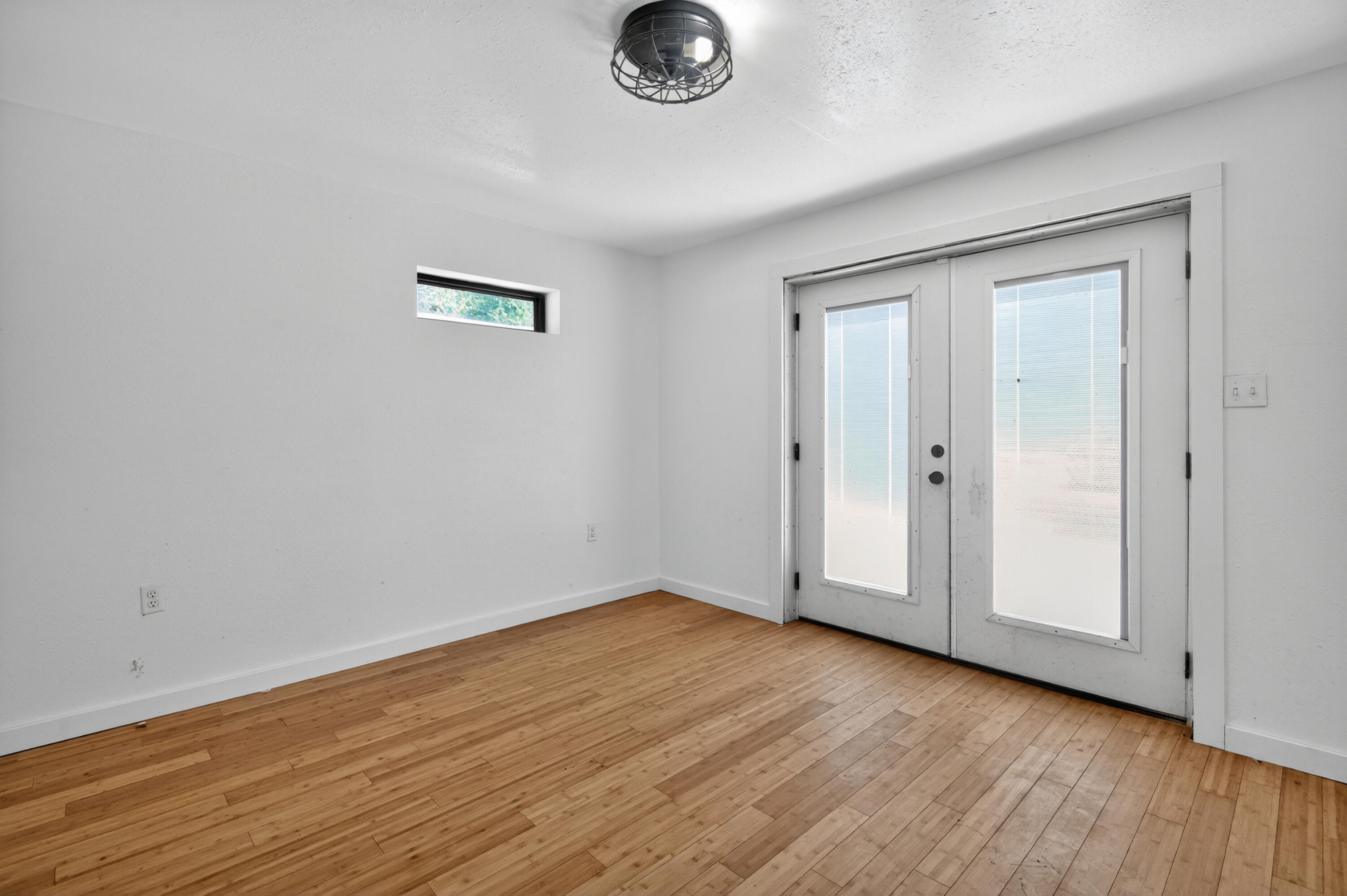 115 Ridgewood Avenue Mary Esther, FL 32569 - Photo 50 of 54 an empty room with wooden floor and window