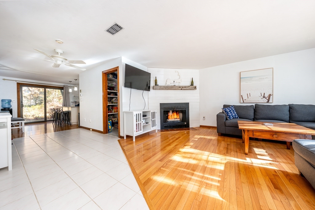 195 Falmouth Road, Unit 9D Mashpee, MA 02649 - Photo 6 of 29 a living room with furniture and a fireplace