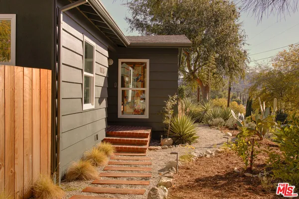 a view of house with backyard and trees