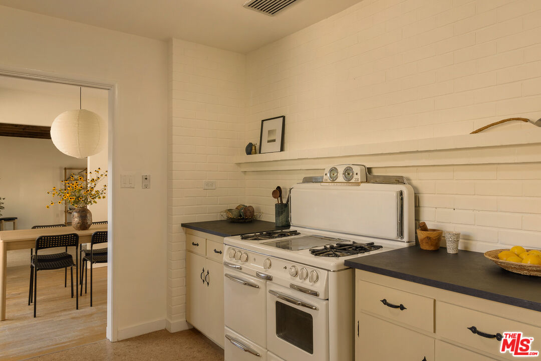 10816 Redmont Avenue Tujunga, CA 91042 - Photo 15 of 31 a kitchen with a stove and a sink