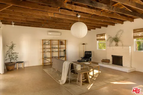 a view of a livingroom with furniture and a fireplace
