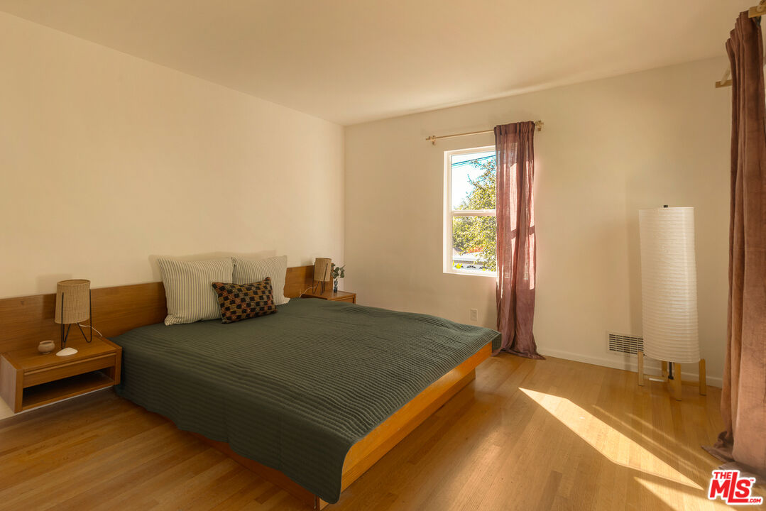 10816 Redmont Avenue Tujunga, CA 91042 - Photo 19 of 31 a bedroom with a bed and a couch