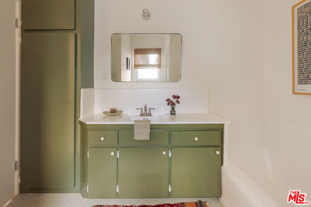 10816 Redmont Avenue Tujunga, CA 91042 - Photo 22 of 31 a bathroom with a sink and a mirror