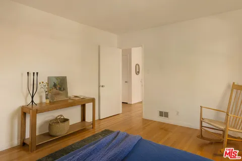 a view of an empty room and wooden floor