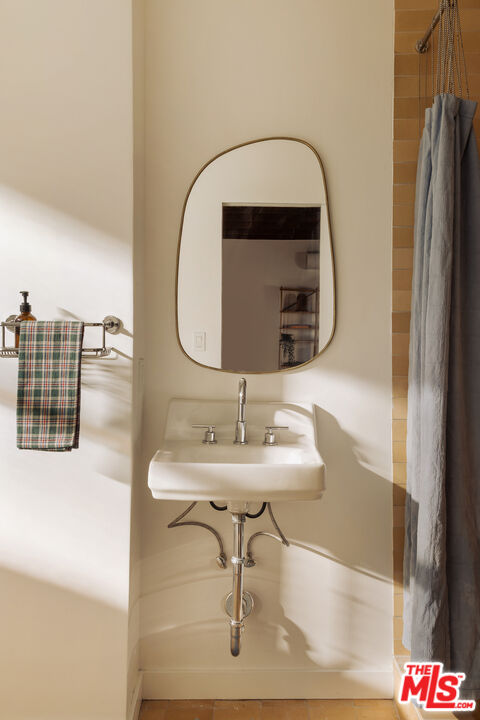 10816 Redmont Avenue Tujunga, CA 91042 - Photo 25 of 31 a bathroom with a sink and a mirror
