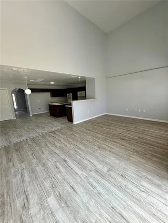a view of a livingroom with an empty space and a window